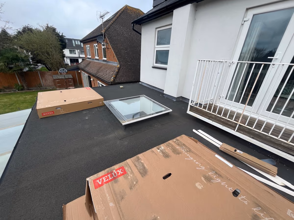 Velux solar window kit delivered on a flat roof in Esher, ready for installation