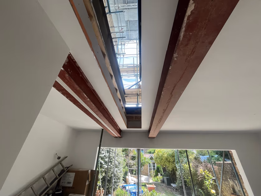 View from inside the extension up through the open rooflight aperture to the scaffolding above