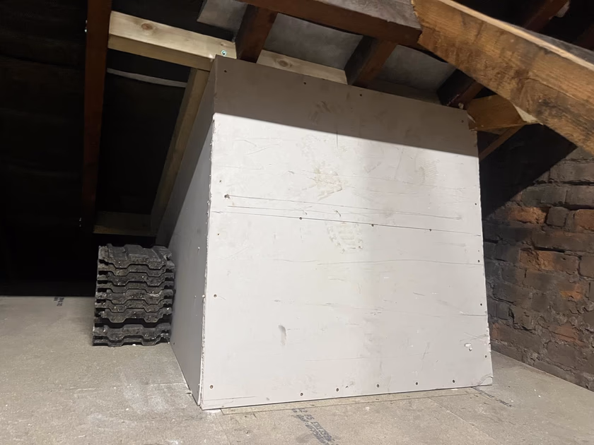The light shaft boxed in with plasterboard inside the loft space