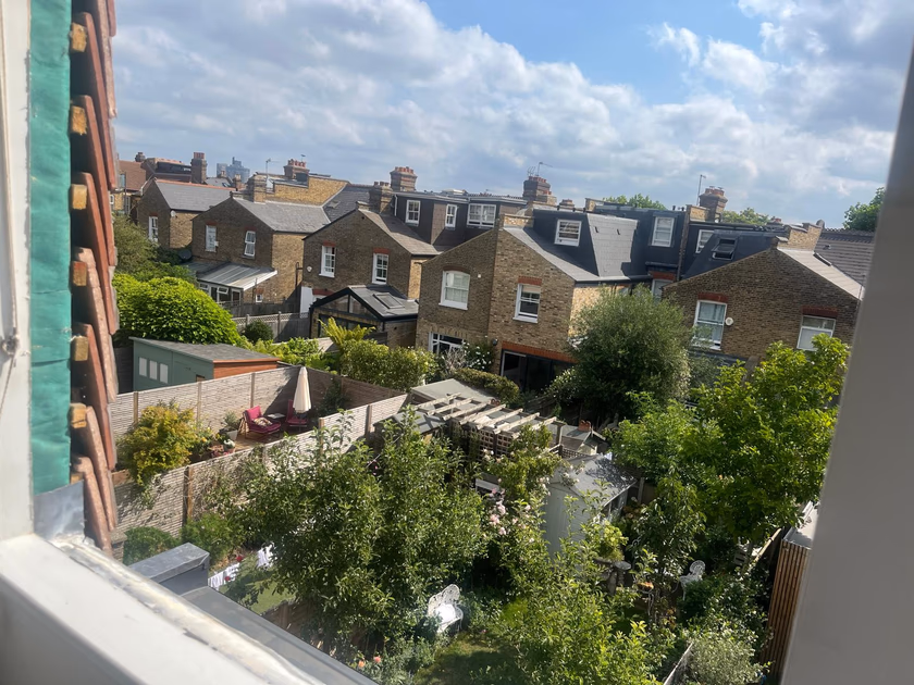 Open window during the sash replacement, looking out over neighbouring gardens and rooftops in Southfields